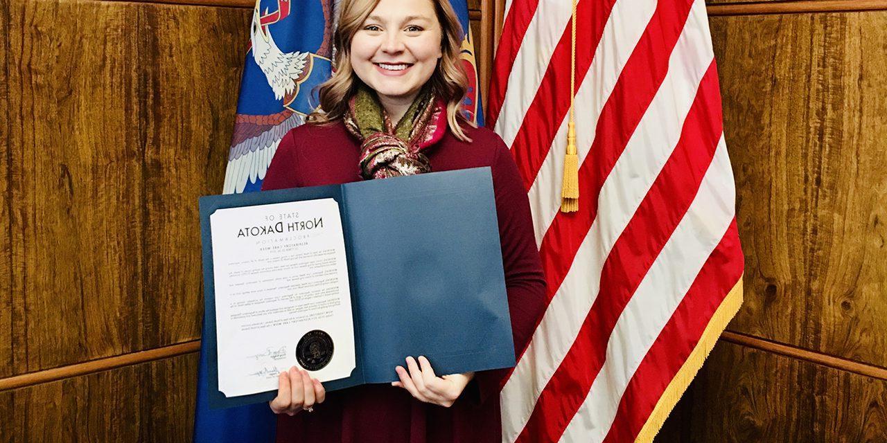 Megan Schneider holds ND Governor Doug Burgum’s Respiratory Care Week Proclamation at the State Capitol